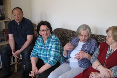 Tenants of Tesanj in Bosnia and Herzegovina converse comfortably inside a warm apartment.